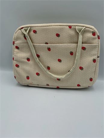 beige corduroy insulated lunch bag with a strawberry pattern